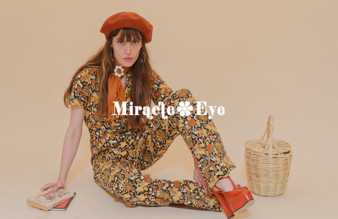 Person wearing a colorful, vintage outfit by Miracle Eye, evoking a bohemian and artistic style.