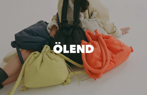 Brightly colored travel bags by Ölend on a table, symbolizing adventure and practical style.