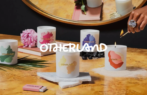 Collection of scented candles by Otherland arranged on a table, creating a warm and welcoming ambiance.